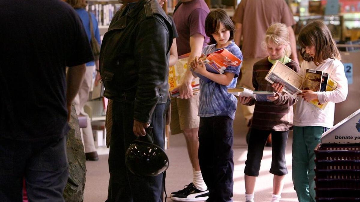 FILE PHOTO: Kids wait in line to check out their books at the Olympia Timberland Library. For the first time in the summer reading program’s 53-year history, Timberland is welcoming adults to join the program. The library also has added online components that are available to people who are out of town, live in rural areas or can’t get a ride to the library.