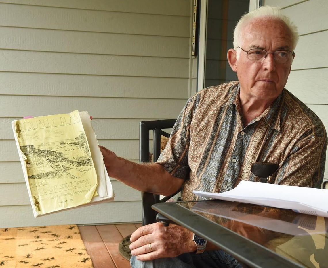Howard Glastetter, sitting on the porch of his Nisqually home Thursday, has been concerned about the proposed asphalt plant at the nearby Lakeside Industries facility for years.