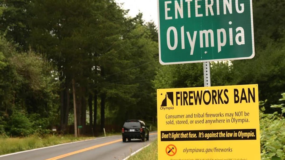 A sign announcing the City of Olympia's fireworks ban is prominently displayed along Wiggins Road SE on Monday.