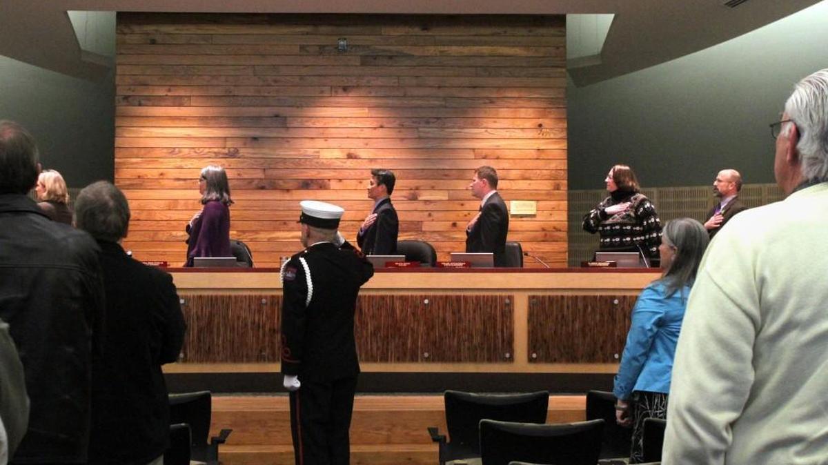Members of the Olympia Fire Department lead the Pledge of Allegiance at the start of the first meeting of the Olympia City Council on April 12, 2011, in the council chambers at the new Olympia City Hall.