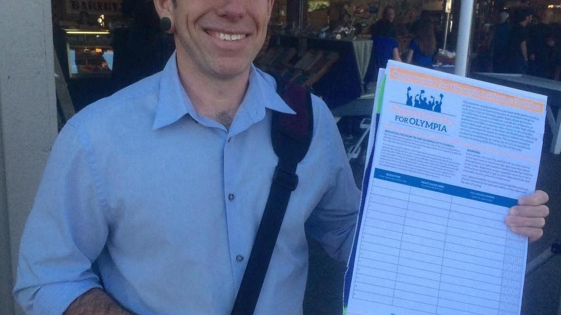 Ray Guerra collects signatures for the Opportunity for Olympia campaign on April 7 at the Olympia Farmers Market.