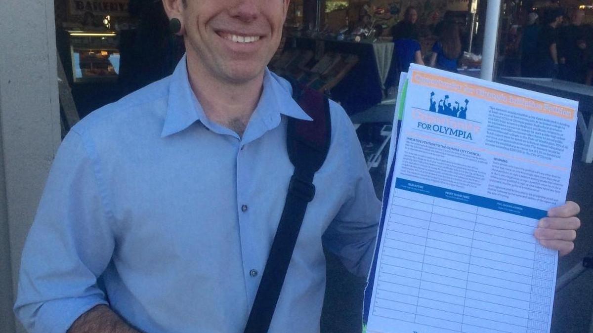 Ray Guerra collects signatures for the Opportunity for Olympia campaign on April 7 at the Olympia Farmers Market.