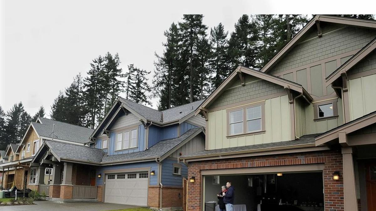 Eatonville residents Marty and Linda Sechrist look down the street at some of the homes in the the Village at Mill Pond residential development off Lilly Road during the open house event.