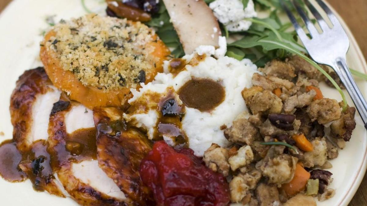 
FILE- A Thanksgiving dinner plate of cider brined turkey with sage gravy, peach cranberry sauce, sour cream and chive mashed potatoes, sausage pecan stuffing, arugula pear salad with pomegranate vinaigrette and goat cheese and herb crusted sweet potatoes.
