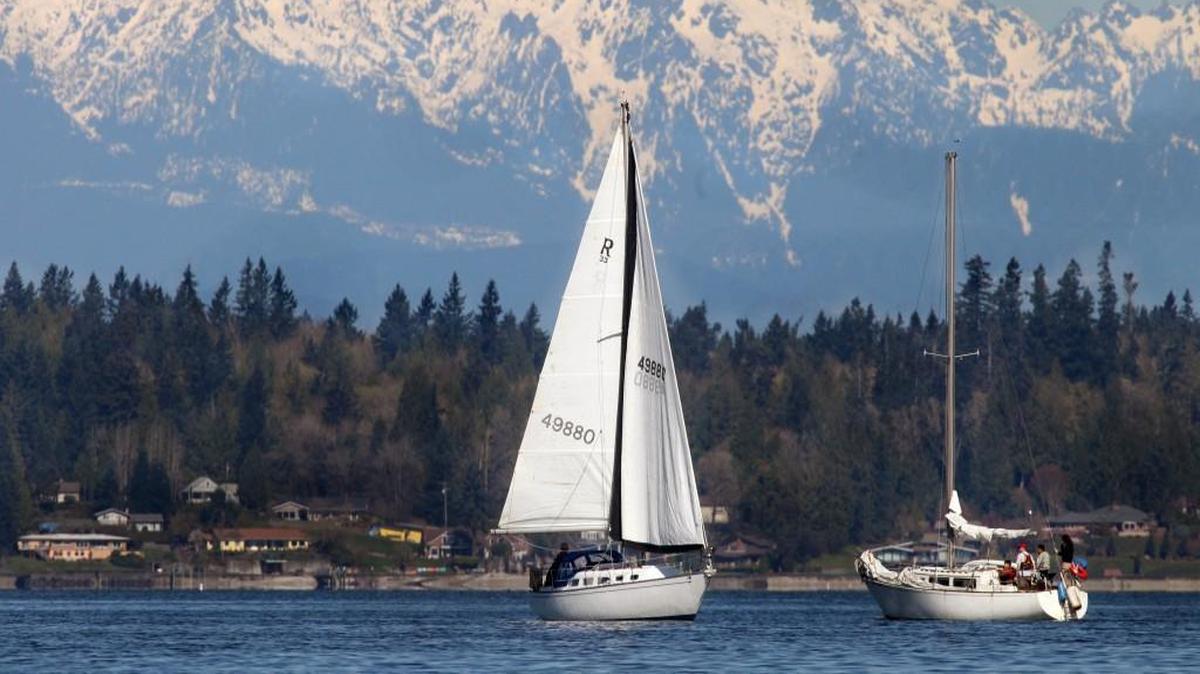 With sails still flying the Soul of Solent passes another sailboat heading out from the East Bay area into Budd Inlet Sunday under the majestic Olympic range on a gorgeous spring day.