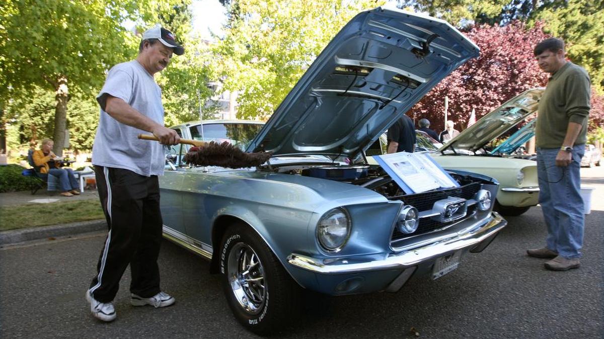 Bill Sebel of British Columbia wipes down his fully restored 1967 Mustang fastback during the 2008 Ponies at the Park car show at Huntamer Park in Lacey. The car show happens again Sunday.