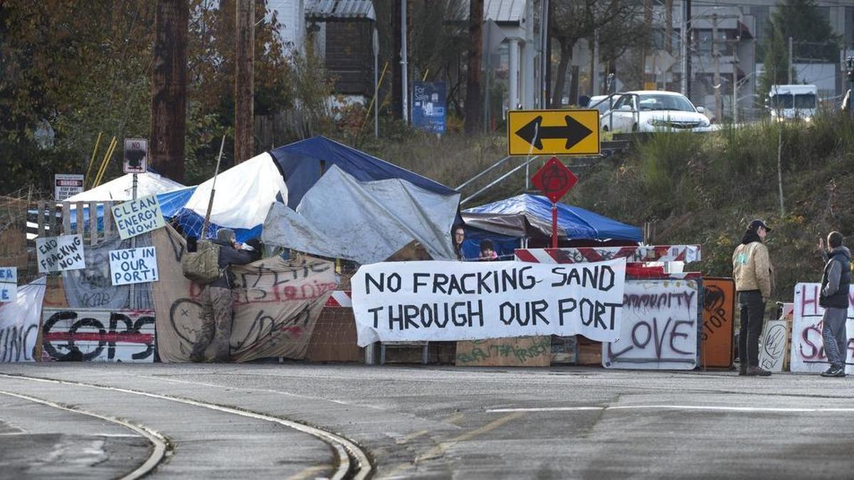 An anti-fracking group blocks the railroad tracks from the Port of Olympia in downtown Olympia on Saturday.