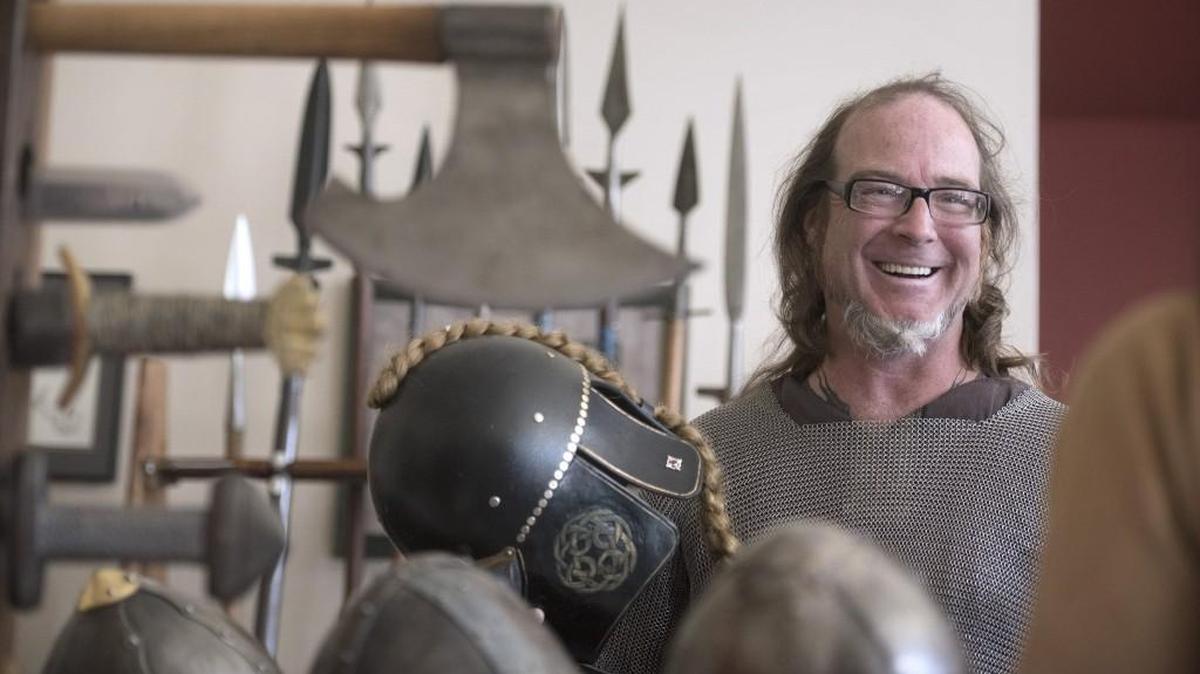 William Koutrouba of Scarlet Arts Design stops by the Vikings North West booth during the 2016 Olympia Norway Day celebration at the Thurston County Fairgrounds and Event Center.