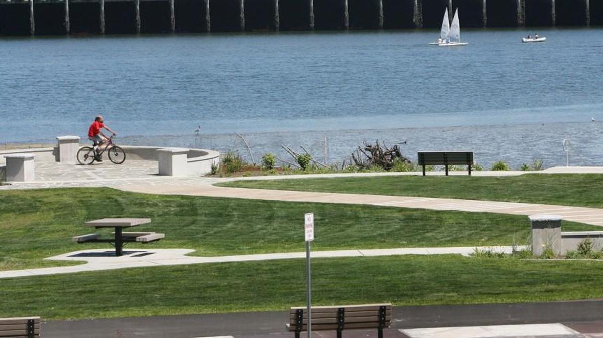 A man bikes through West Bay Park shortly after it opened in 2010.