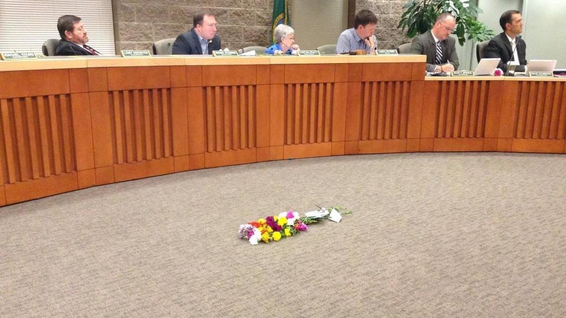 A bouquet of flowers, meant to represent those who have died living on the streets, was placed on the floor before Lacey City Council Thursday night.