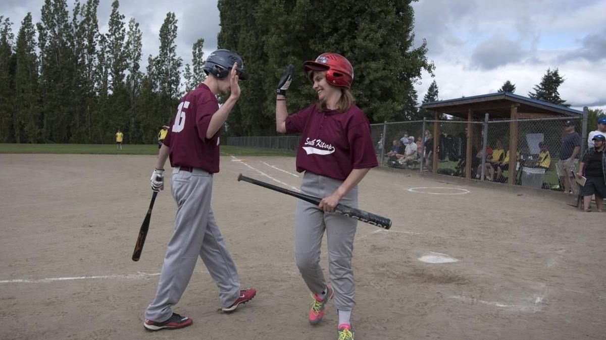Robert Olsen gives a high five to SK Wolves teammate Shaneey Skelton during their opening-round game of the 2016 Southwest Region Special Olympics Softball Tournament at LBA Park in Olympia. This year’s tournament runs from 9 a.m. to 5 p.m. at both LBA and Yauger parks in Olympia.