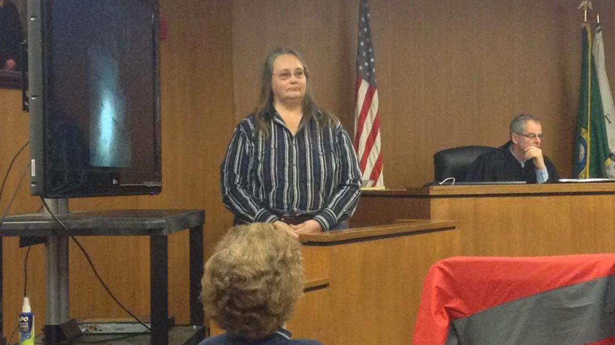 Debbie Lattin stands to explain some photographs to the courtroom during the final day (Thursday) of the Lattins’ goat-abuse case.