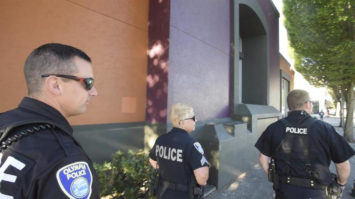 Officer Josh Marcuson, left, Sgt. Amy King and officer Sean O’Brien on walking patrol in downtown Olympia. King,the unit’s superior, says her goals are to engage with people while also addressing criminal activity.