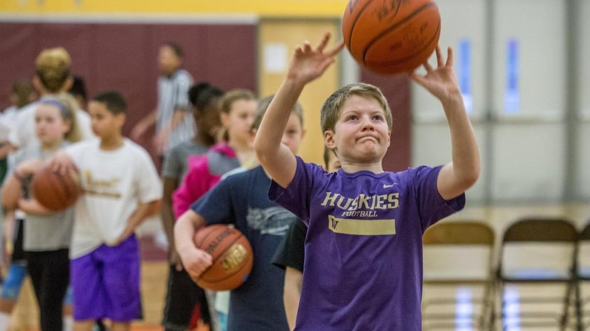 Kids get warmed up by shooting free throws before the Tacoma Elks Hoop Shoot held at Mount Tahoma High School on Saturday.
