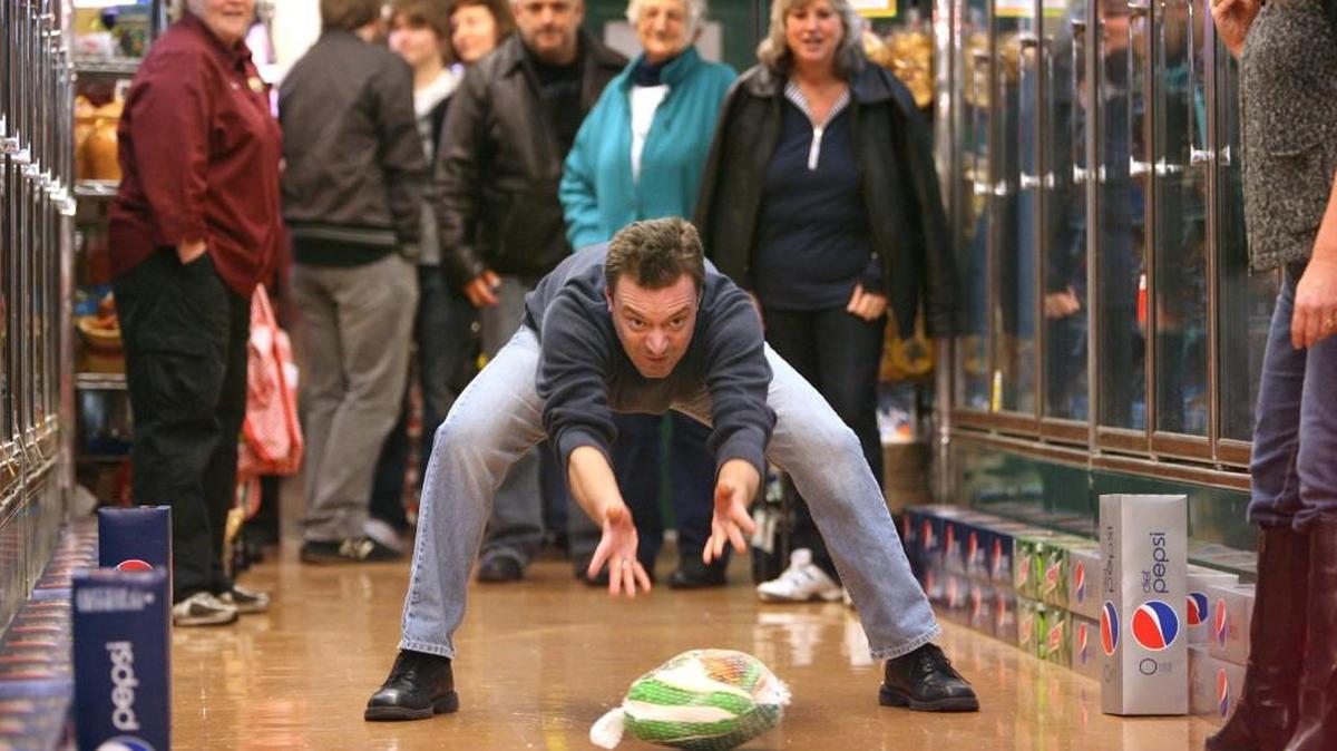 David Horgen of Olympia slides a turkey down the frozen food aisle at Bayview Thriftway during the store's first Turkey Bowl in 2009.