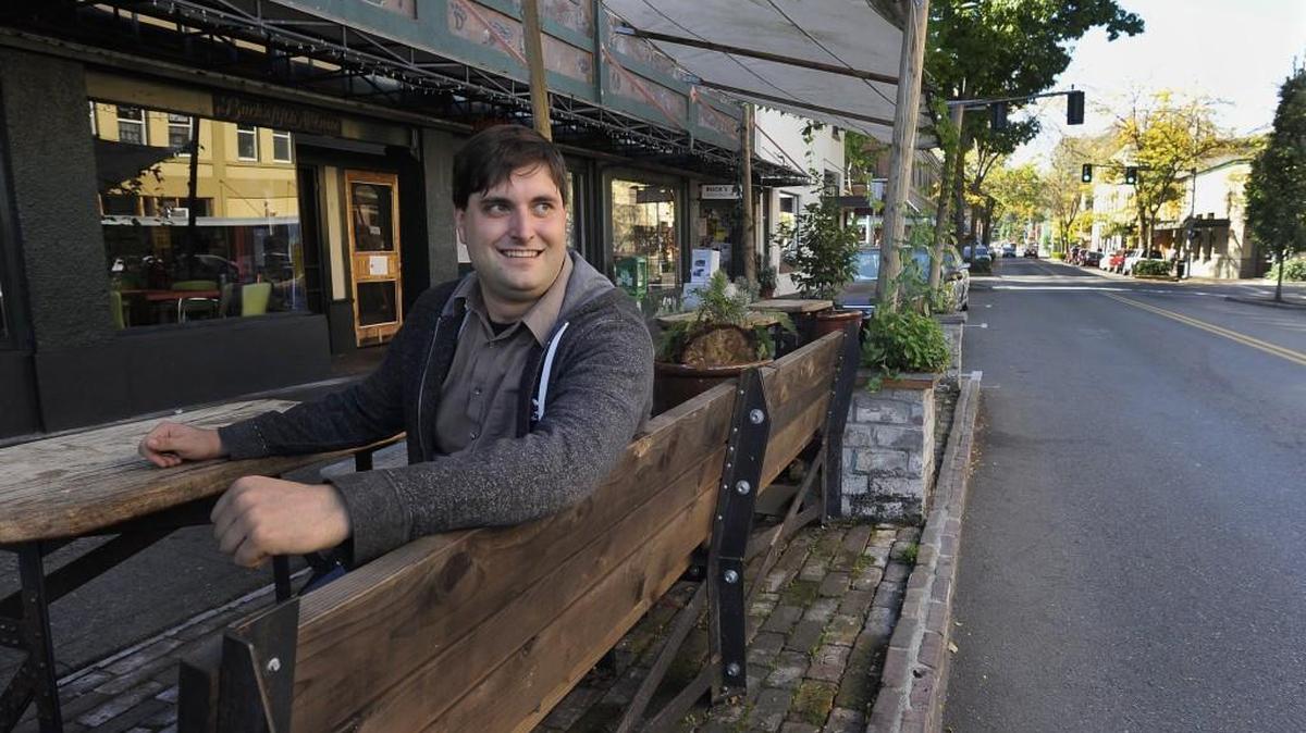 Former downtown liaison Brian Wilson sits in September in the covered parklet area on Fifth Avenue in Olympia. The seating is part of one of the civic projects completed during his tenure. Now, the city seeks the public’s input on whether these types of projects are beneficial for downtown.