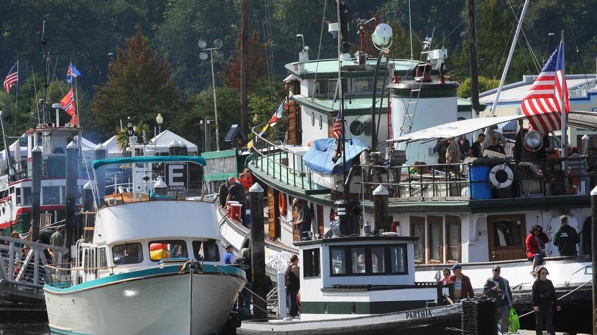 Visitors and spectators pass along tugboat row at Percival Landing during the 2016 annual Harbor Days Tugboat Races and Festival.