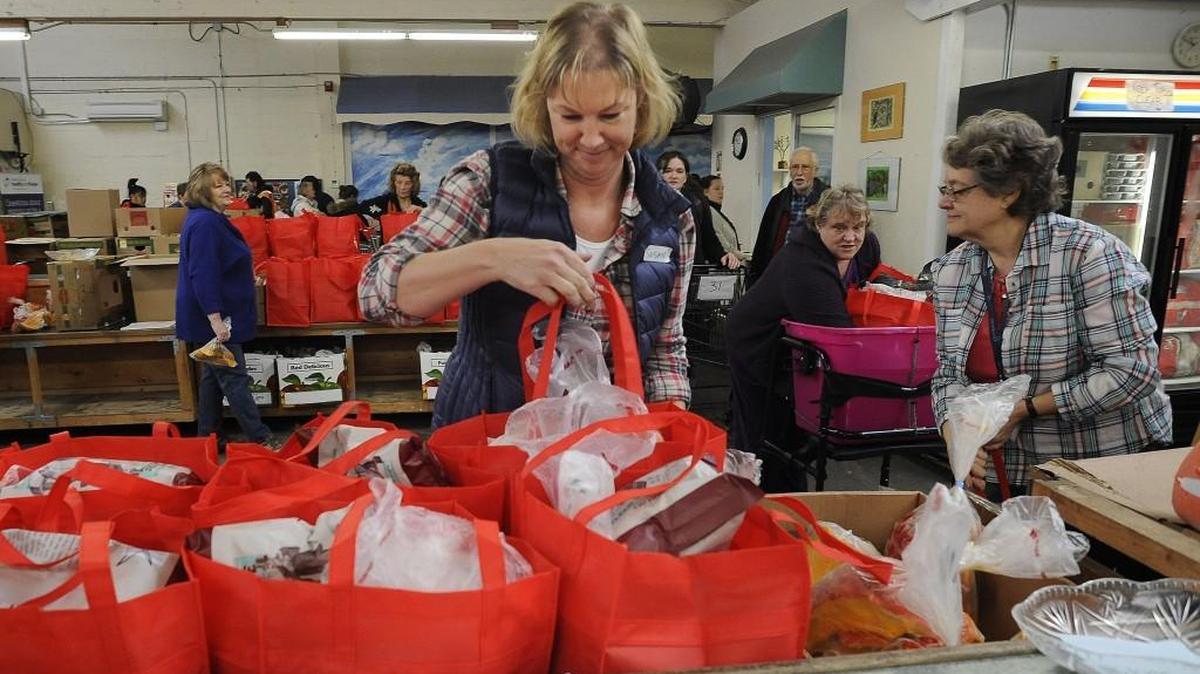 Thurston County Food Bank volunteer Susan Clemen helps fill up some of approximately 4,000 Thanksgiving food baskets distributed Nov. 23.