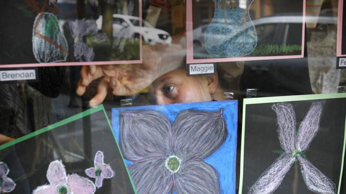 Audrey Daye of Olympia prepares pastel drawings by Lincoln Elementary second- and third-graders in the front window of Radiance during the opening day of spring Arts Walk in downtown Olympia on Friday, April 24, 2015.