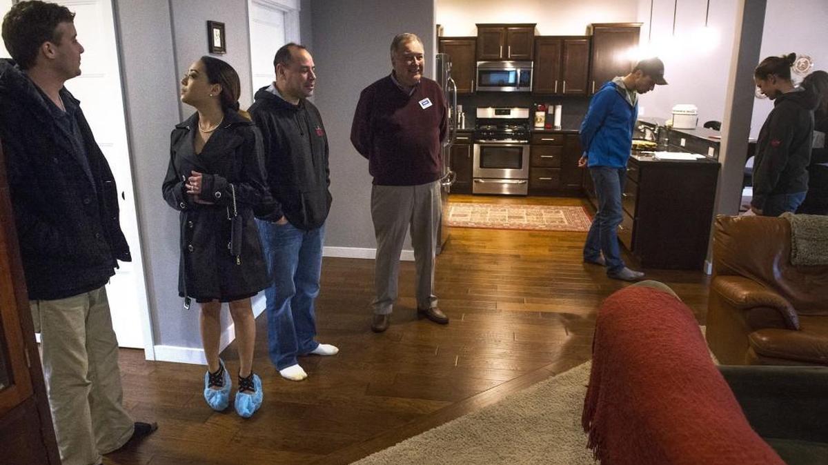 Lee and Kat Anderson (from left) of Olympia tour an open house in The Village at Countryside development in Tumwater along with realtors Juan Delgado and Casey Jones on Sunday, Jan. 21, 2018.