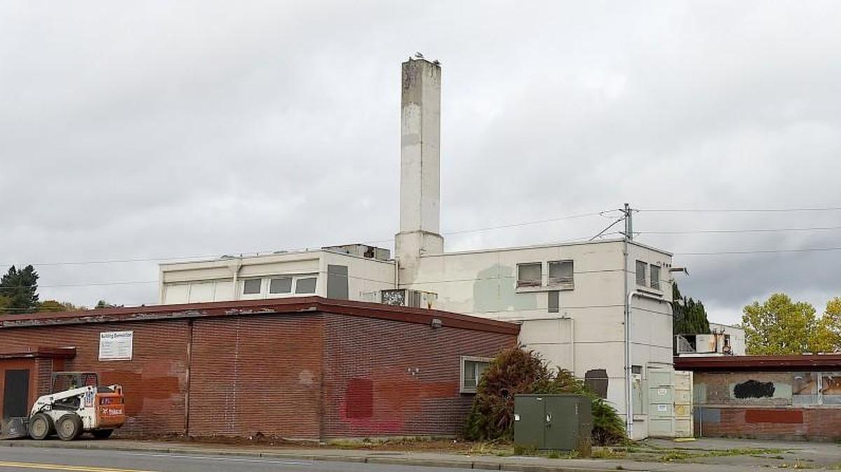 A work crew cleans and clears the perimeter around the vacant Thurston County health Dept. building October 19 as the City of Olympia’s contractor, WM Dickson Co., prepares to begin demolition at 529 Fourth Avenue West.