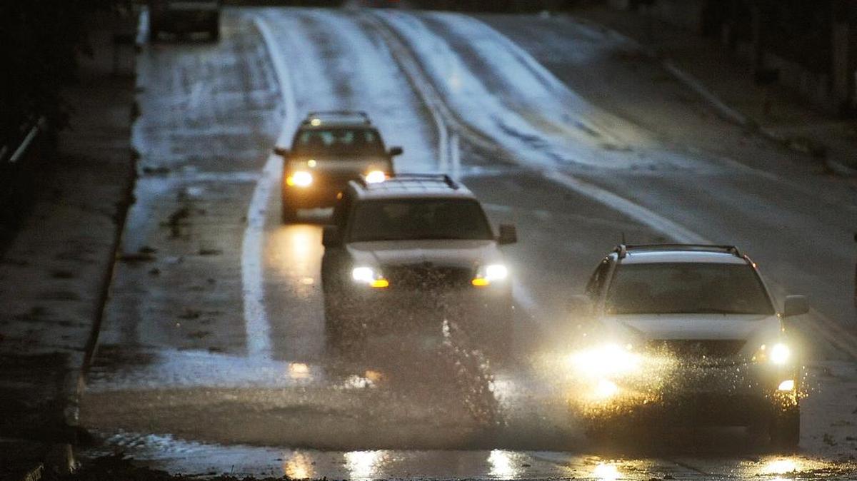 Friday morning commuters try to skirt standing water along Olympia’s Boulevard Road.
