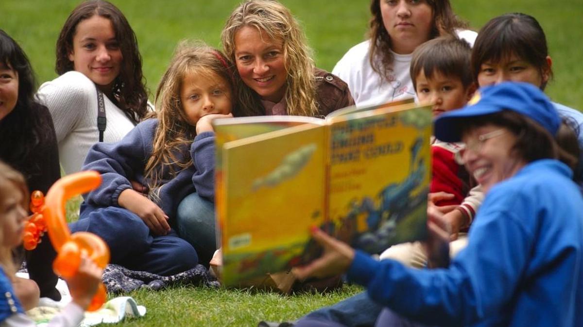 Staff file: The Champagne family (from left) Rebecca, 16 Eli, 8, mom Zoe, and Shelby, 14, listen to South Sound Reading Foundation volunteer Lois Asay read "The Little Engine That Could" in 2008. The nonprofit is rescheduling a volunteer storytime training that was set for today.