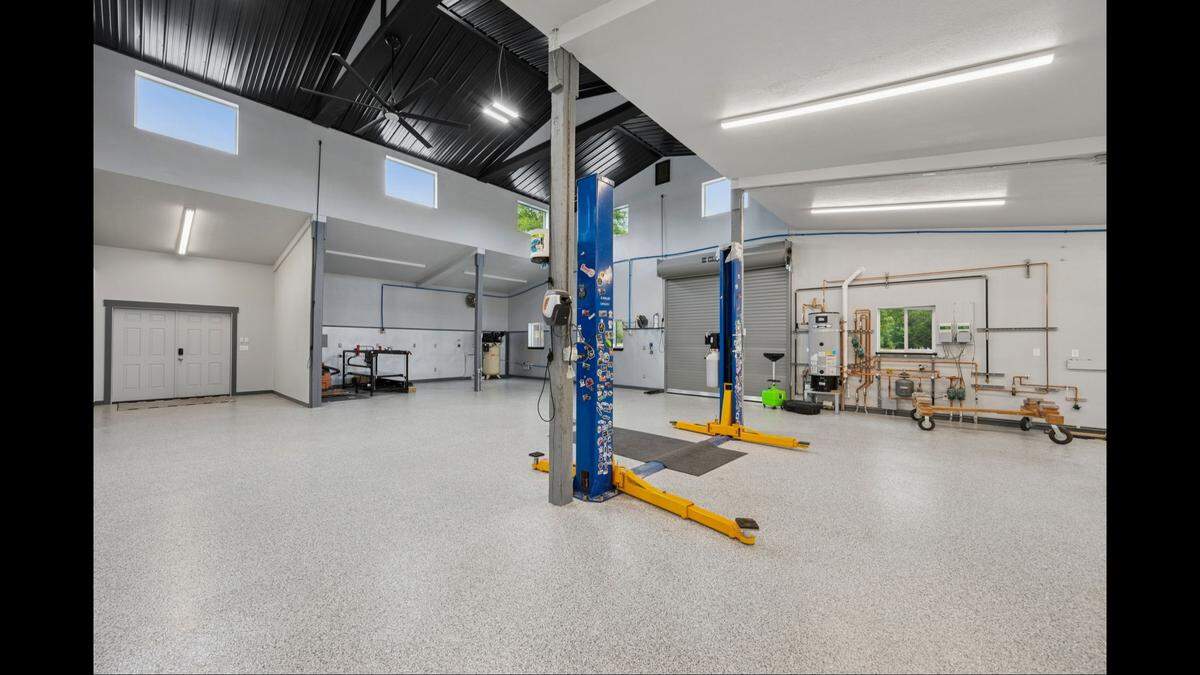 A car shop with a lift and other features is part of a home on the market in Olympia.