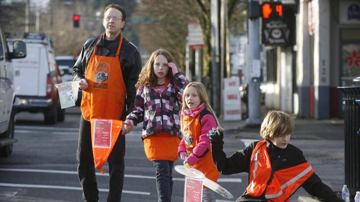 The Kelley family of Olympia takes to the streets to help raise money during the annual Mixx 96.1 Holiday Toy & Fund Drive in downtown Olympia in 2012. The local radio station will again collect cash and toys on Friday.