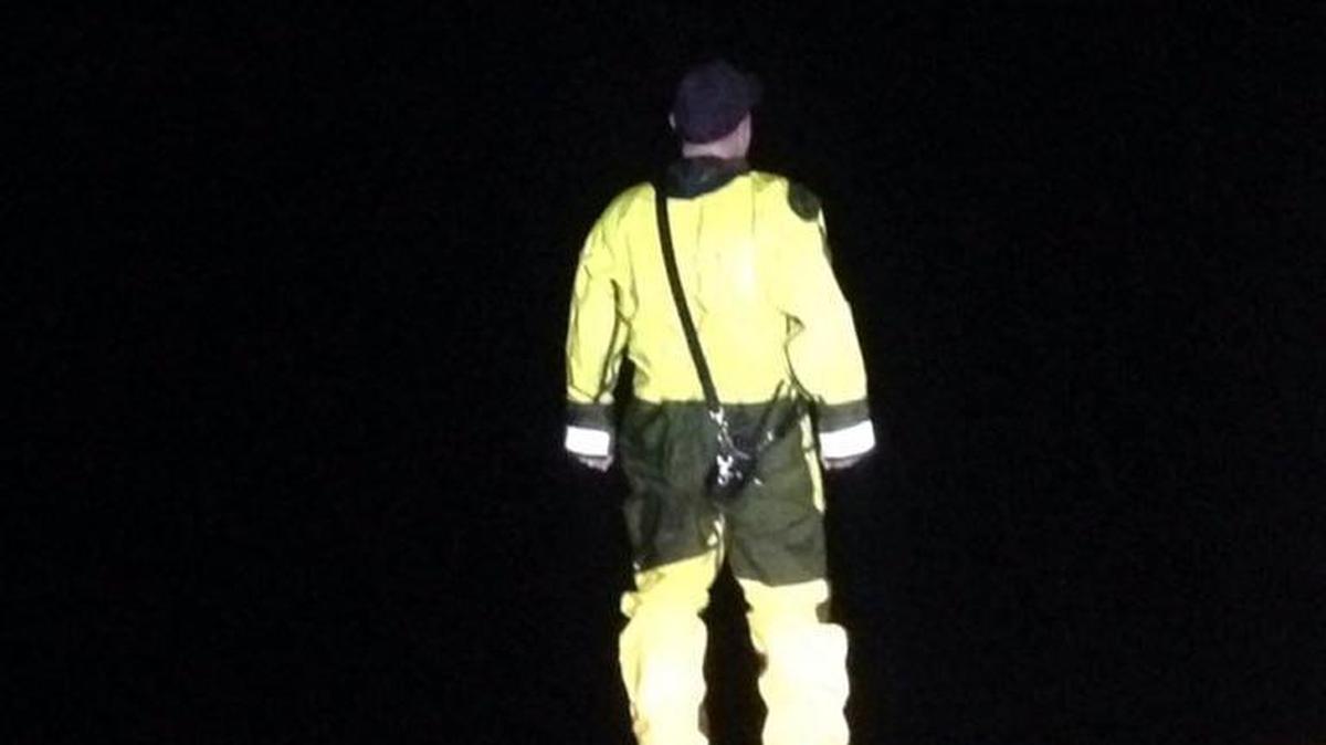 A Lacey Fire District 3 crew member looks into the distance Saturday night to find a University Place man who had gotten stuck in the mud near the Nisqually Wildlife Refuge.