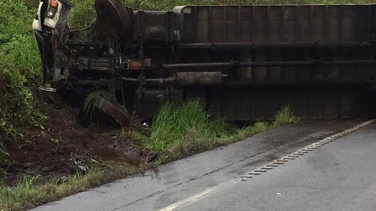 A semitruck lays on its side following a Tuesday morning crash on Old Highway 99.