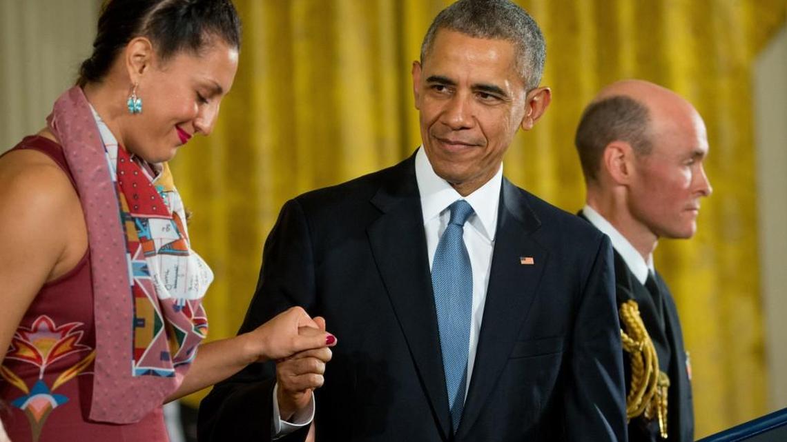 President Barack Obama helps Peggen Frank to the lectern as she accepts the Presidential Medal of Freedom for her father-in-law, the late Indian tribal advocate Billy Frank Jr., on Tuesday.