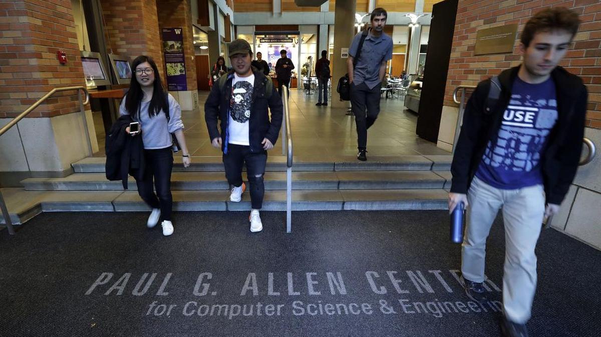 Students walk out of the Paul G. Allen School of Computer Science & Engineering at the University of Washington in Seattle. Prior to his death on Monday, Allen invested large sums in technology ventures, research projects and philanthropies, some of them eclectic and highly speculative. Outside of bland assurances from his investment company, no one seems quite sure what happens now.
