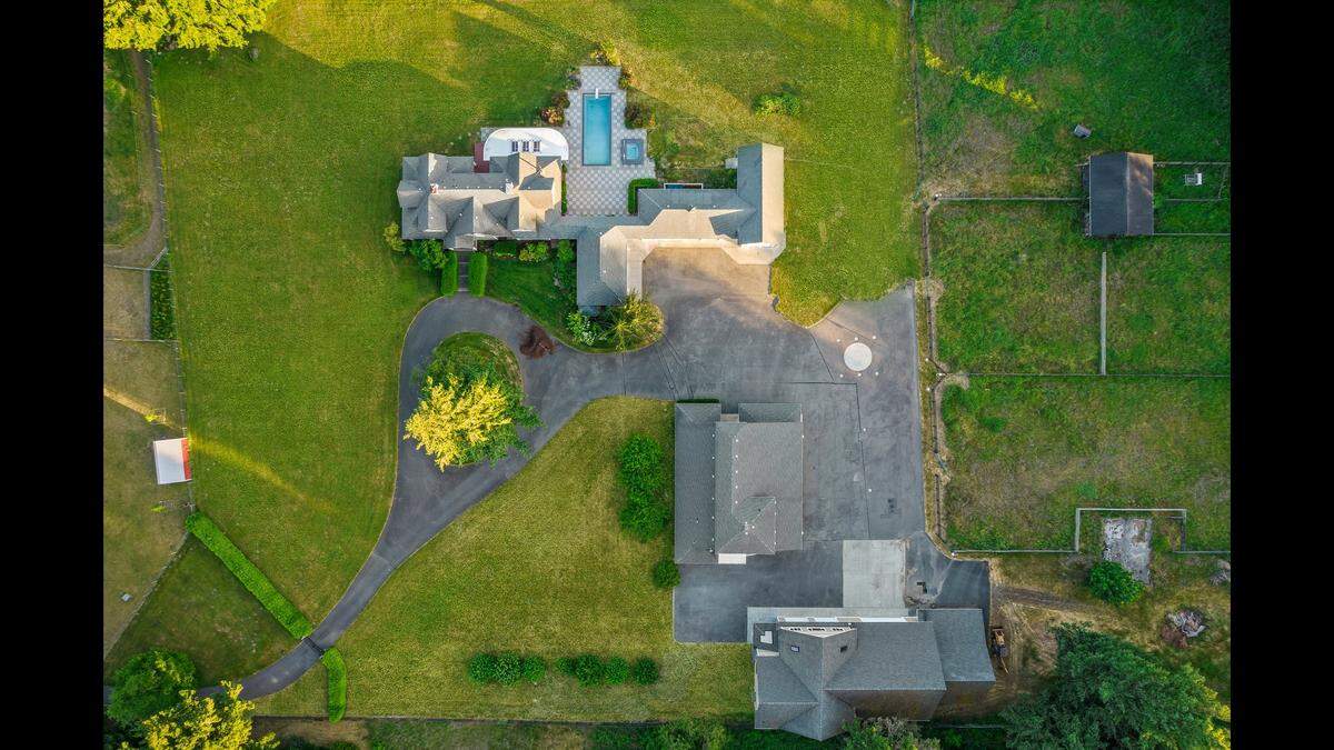 A $2.4 million estate on the market in Olympia has a main home, a barn with a living space above, plus a helicopter shop and more.