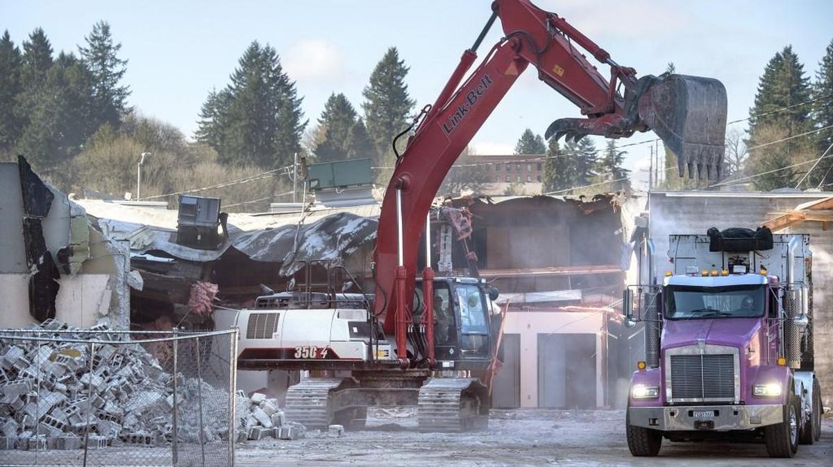 Crews tears down a single-story building next to the long-vacant Capitol Center Building as part of the Views on Fifth renovation in downtown Olympia on Tuesday. A group fighting to stop the renovation has filed a land use petition in Thurston County Superior Court.