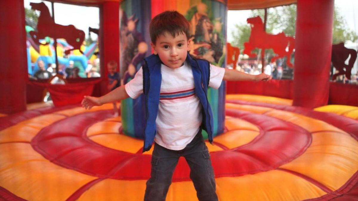 A boy bounces in the inflatable carousel during the Lacey Spring Fun Fair at Saint Martin’s University in 2012.