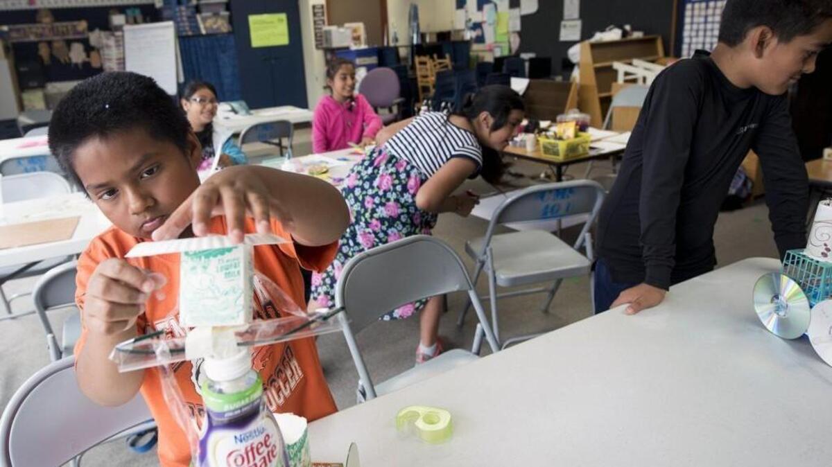 Steven V., 9, a soon-to-be fourth-grader, builds a toy car out of recyclables during Centralia School District's Migrant Summer School program at Edison Elementary. A new grant-funded summer school program in Centralia aims to give migrant students a head start.