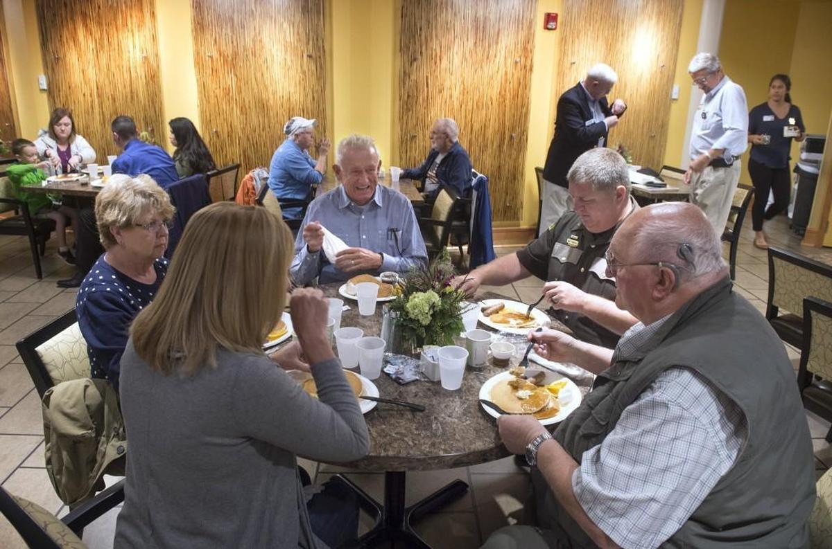 Former Secretary of State Ralph Munro, center, dines with Thurston County Sheriff’s Chief Deputy Dave Pearsall, second from right, and his family during the pancake breakfast fundraiser for Sheriff John Snaza at Seventeen51 Restaurant & Bistro at Panorama in Lacey in 2016.