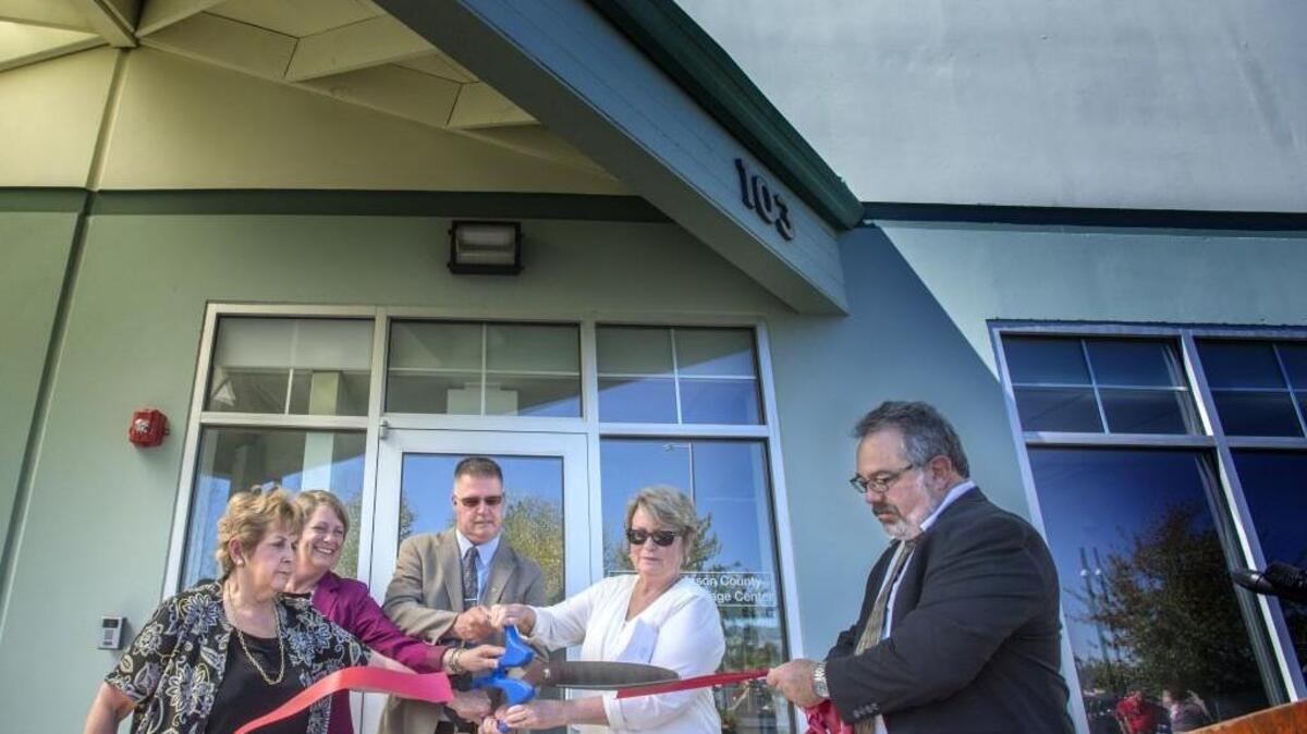 Thurston County and Mason County officials cut the ribbon during a dedication ceremony at the Thurston-Mason Mental Health Triage Center in Tumwater on Aug. 25, 2016.