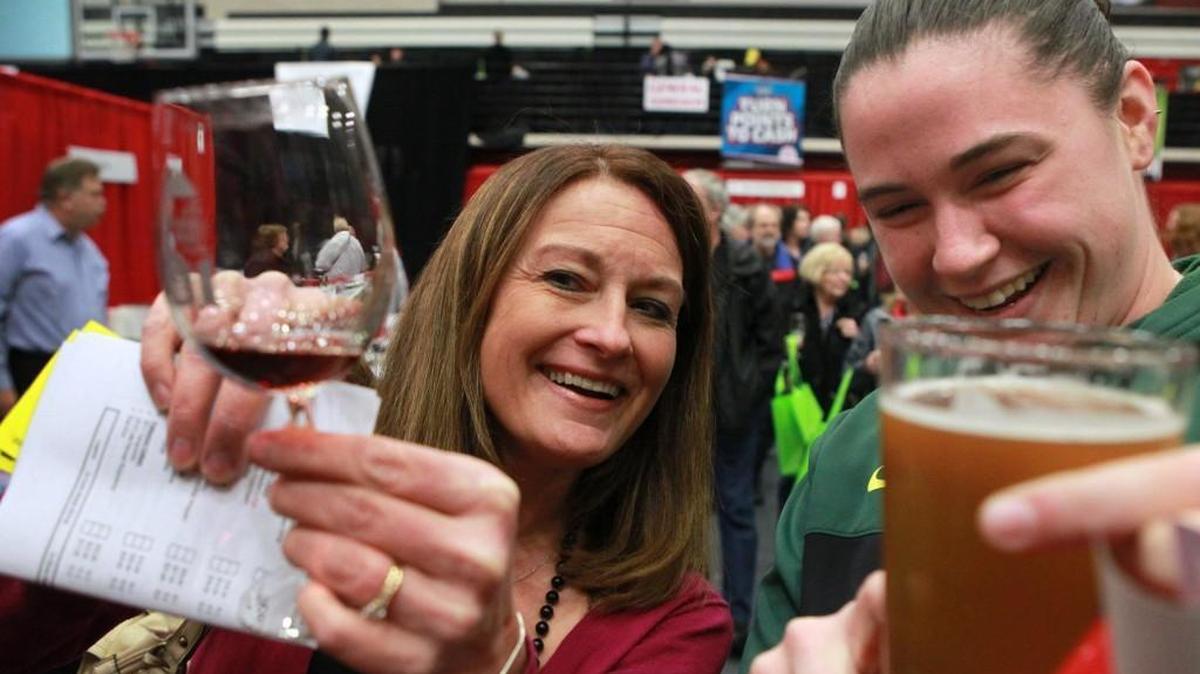 Debra Floyd (left) of Lacey and Krissy Bassett of Yelm compare their wine and beer samples during the annual Capital Food and Wine Festival at Saint Martin’s University in 2014. Bassett played basketball for SMU and graduated in 2011.