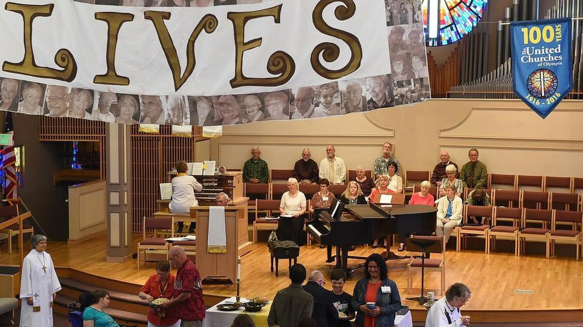 United Churches' Associate Transitional Pastor Rev. Jill Komura (left) watches the communion ceremony as she conducts the May 1st service with theme,"In Service of Our Country", as a remembrance of veterans.