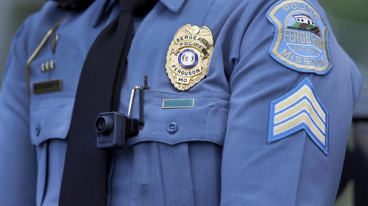 In this July 23 photograph, Ferguson police Sgt. Dominica Fuller wears a body camera as she speaks during an interview in Ferguson, Mo. Within weeks of Michael Brown’s death, Ferguson police began wearing the cameras that were donated to the city.