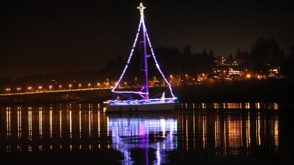 One of the 14 boats decorated with Christmas lights shines on Budd Inlet as the 2010 Parade of Lighted Ships rolls out from the Olympia Yacht Club. The 2016 parade is Dec. 3.