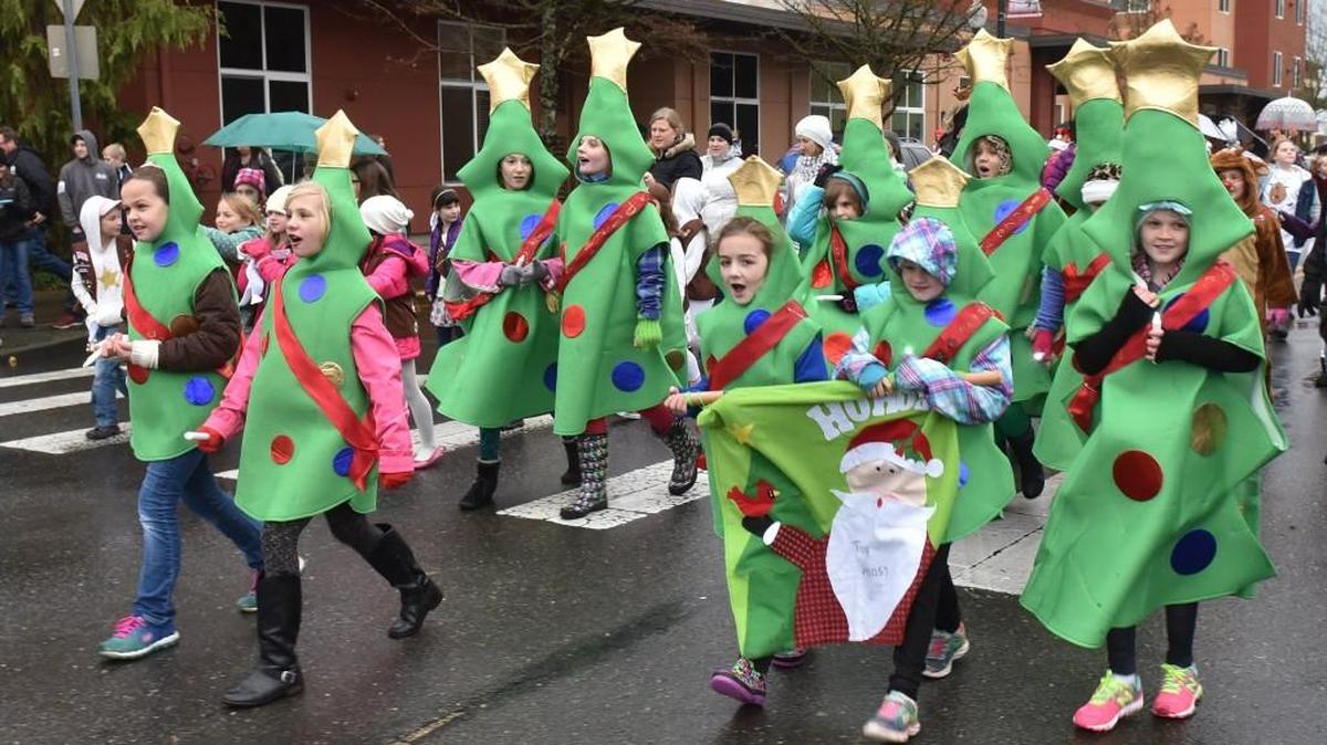 Girl Scouts dressed as Christmas trees head down Capitol Way during the 2016 Downtown for the Holidays Parade in Olympia.