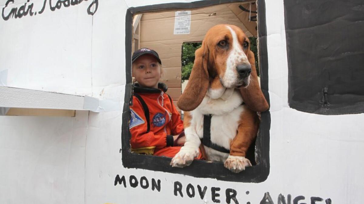 FILE PHOTO: Rosalyn Tobeck and her bassett hound, Angel, wait inside their space shuttle for take-off of the 80th Annual Pet Parade in downtown Olympia in 2009. “Pets in Space” is this year’s theme.