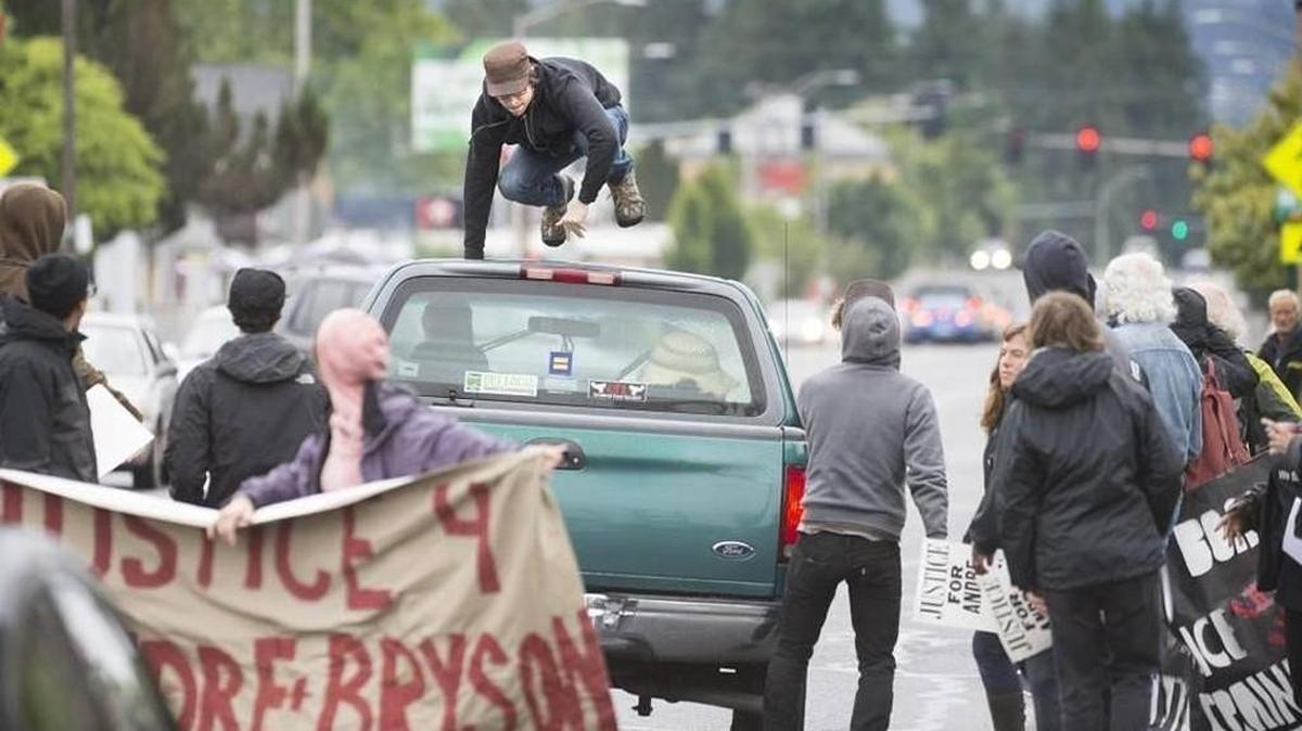 A man climbs on top of a truck that was trying to get through Olympia’s blocked Harrison Avenue at the start of a protest march on the anniversary of the police shooting of Andre Thompson and Bryson Chapman in west Olympia on Saturday, May 21. The driver of the truck later apologized for driving through the crowd, and that story was one of the most read stories last week at www.theolympian.com. Tony Overman toverman@theolympian.com