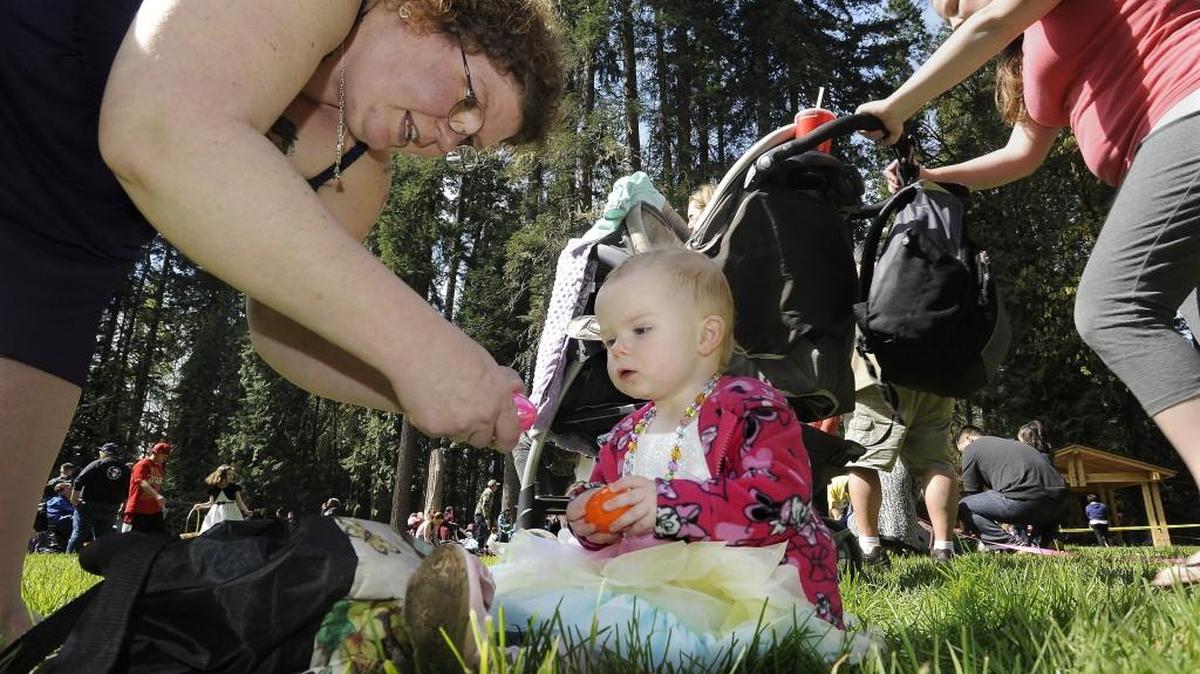 Jazzlyn Lewis, 2, tallies up her collection with help from her mother, Janel, as they joined an estimated 1,200 other young egg hunters for the 2015 Olympia Eagles annual Easter Egg Hunt at Priest Point Park in Olympia. For a list of 2017 egg hunts, see What’s Happening.