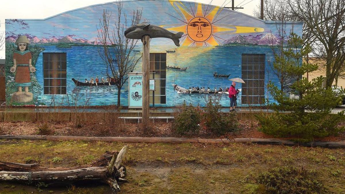 With the still-vibrant mural depicting the 2012 Paddle to Squaxin event displayed on its westside wall, the vacant Les Schwab waterfront property at 210 State Ave. next to Percival Landing has been purchased by downtown Olympia developer Walker John, who hopes to turn it into a commercial space with a restaurant and 40-plus apartments.