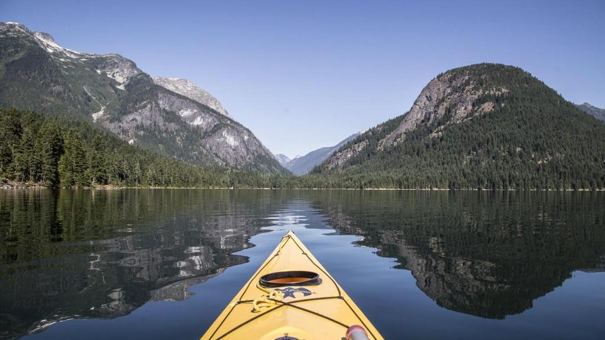 Paddling on Ross Lake, with Pumpkin Mountain at right, looking toward the saddle that contains Big Beaver Creek trail in North Cascades National Park. Lauren Danner, author of “Crown Jewel Wilderness,” a book about the creation of North Cascades National Park, will host a meet-the-author and book signing event at 7 p.m. Thursday at Browsers Bookshop in Olympia.