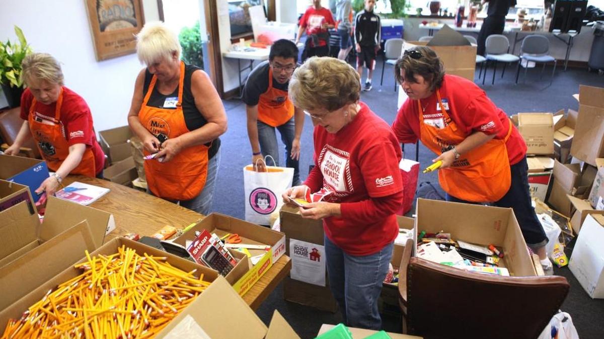 Barbara McLean (center) and fellow volunteers gather and sort donations for the Little Red Schoolhouse Project during the "Radio Day" fundraiser at MIXX-96.1 radio station in Olympia in 2012. The annual Little Red Schoolhouse event provides free clothing, backpacks and school supplies for any student enrolled in Thurston County schools.